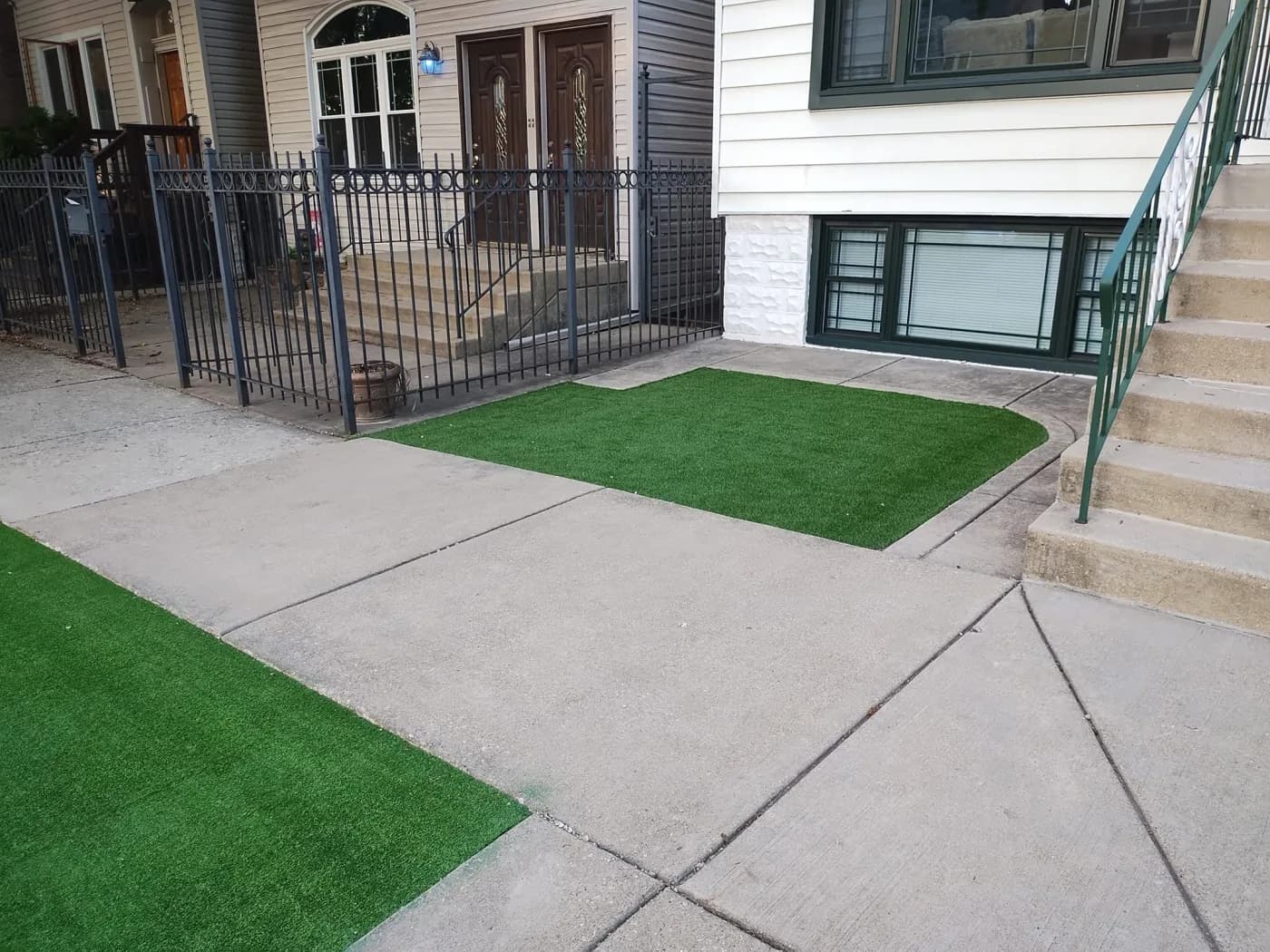 Turf panel set flush into a concrete entry